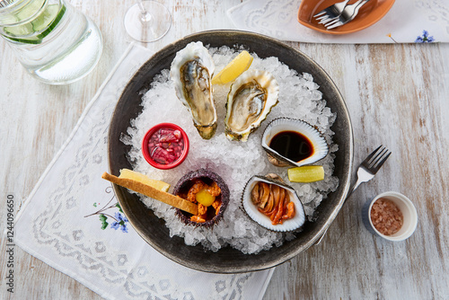 Elegant Seafood Platter with Oysters, Sea Urchin, and Anadara on Ice - Rustic Photography photo