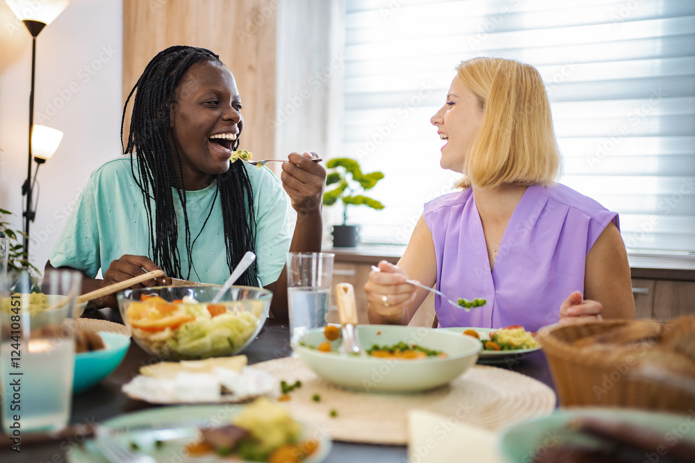 Friends enjoy a joyful meal together in a cozy dining space Friends enjoy a joyful meal together in a cozy dining space