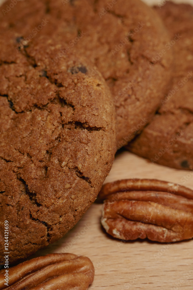 chocolate chip cookies with pecan on a wooden table close up chocolate chip cookies with pecan on a wooden table close up