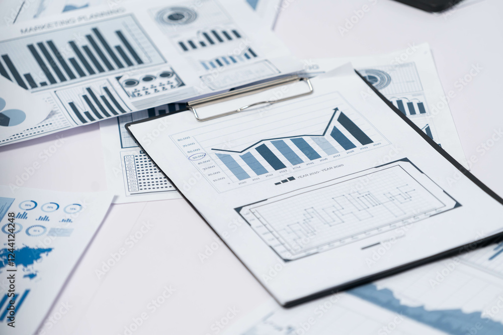 Piles of business intelligence paper or BI financial report and financial data visualization on paperwork for business analytic marketing and strategic planning at office desk. Prudent Piles of business intelligence paper or BI financial report and financial data visualization on paperwork for business analytic marketing and strategic planning at office desk. Prudent