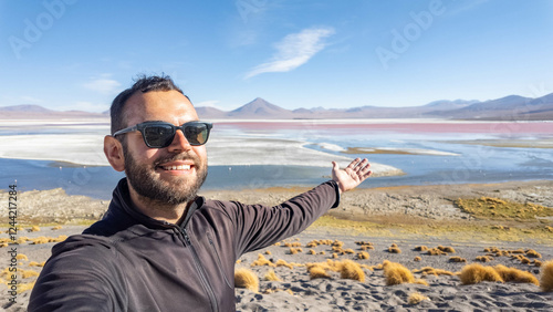 bearded traveler taking a selfie at Pukaqucha the red Lagoon in  Eduardo Avaroa Andean Fauna National Reserve Bolivia photo