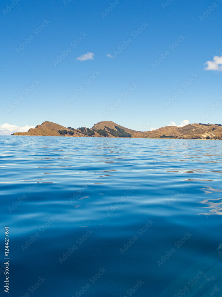 View of the Sun island in Titikaka lake bolivia from a boat View of the Sun island in Titikaka lake bolivia from a boat