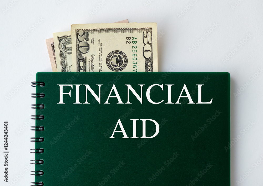 On white background, a calculator, a white sheet with the text FINANCIAL AID, a pen. Business Concept On white background, a calculator, a white sheet with the text FINANCIAL AID, a pen. Business Concept