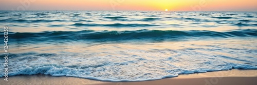 Serene ocean scene with soft blue waters and gentle waves on a warm sandy beach at sunset  water texture  sandy shore