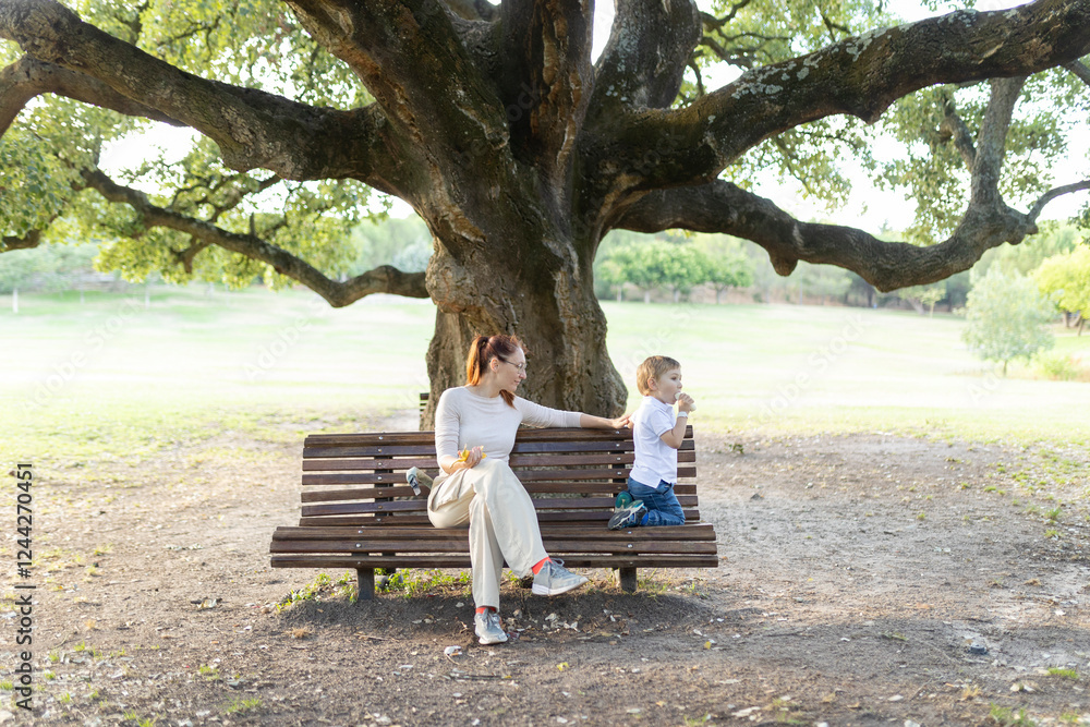 Mother and son sharing a pleasant moment on a park bench Mother and son sharing a pleasant moment on a park bench