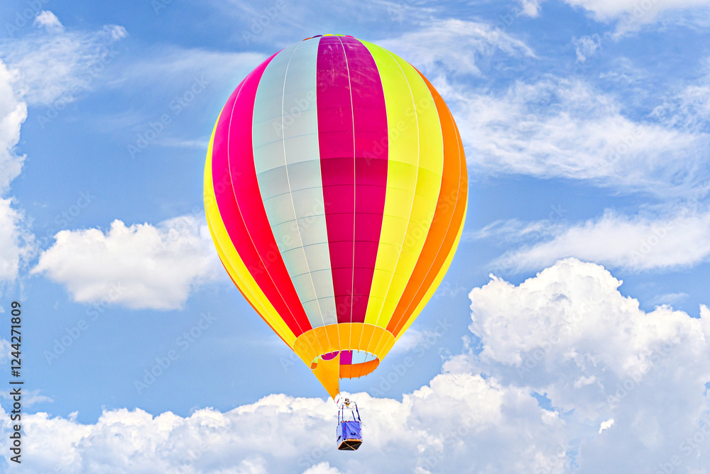 Fototapeta premium Colorful hot air balloon flying over blue sky with white clouds 