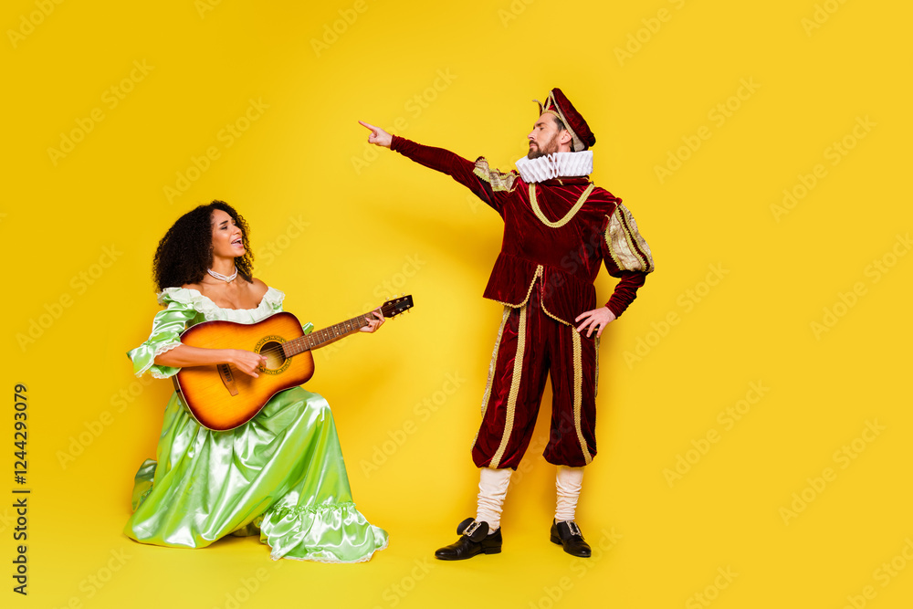 Fototapeta premium Couple in Bright Costumes Enjoying Music Together Against Yellow Background