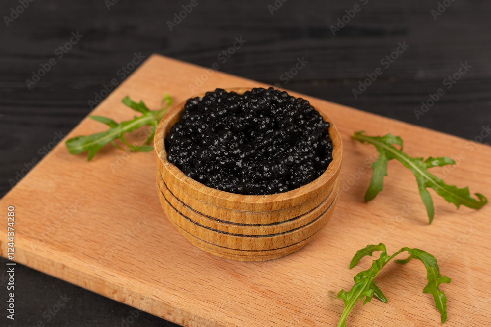 Bowl with black caviar on on wooden table Bowl with black caviar on on wooden table
