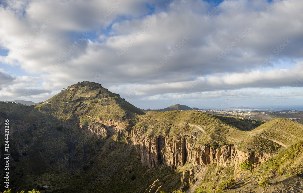 Mountainous landscape in Gran Canaria with a sea of clouds partially covering the slopes.