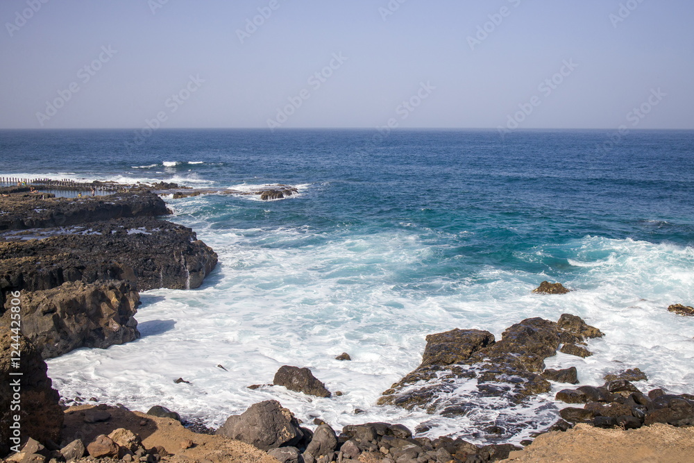 Waves crashing against a rocky shoreline in Gran Canaria.