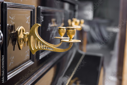 Obraz na płótnie Close-up of a grand piano with ornate, golden ormolu candle holders. w salonie
