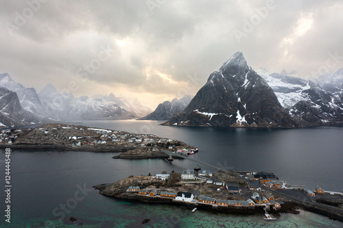 A drone shot of clouds and sunset over a mountain and ocean fjord in Norway.  photo