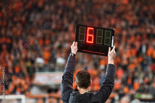 Technical referee shows 6 minutes added time during the football match. photo