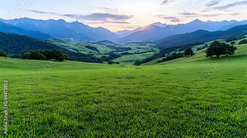 Sunset over grassy valley, mountains background, peaceful landscape, travel poster