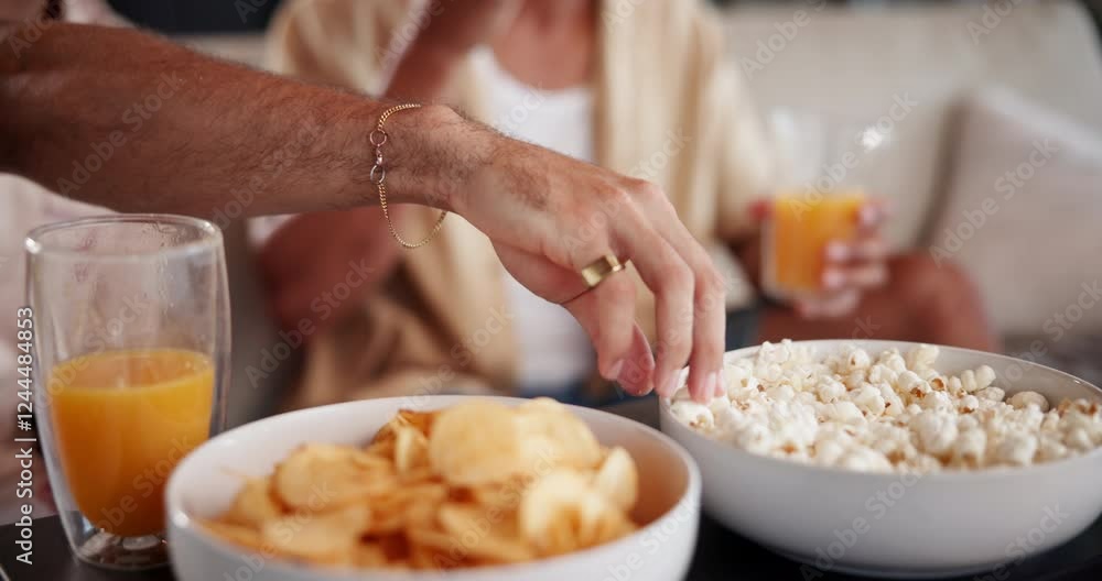 Relax, hands and people with popcorn, chips and food for watching tv show with fiber and nutrition. Eating, potato snacks closeup and friends on couch for movies, television or weekend in living room Relax, hands and people with popcorn, chips and food for watching tv show with fiber and nutrition. Eating, potato snacks closeup and friends on couch for movies, television or weekend in living room