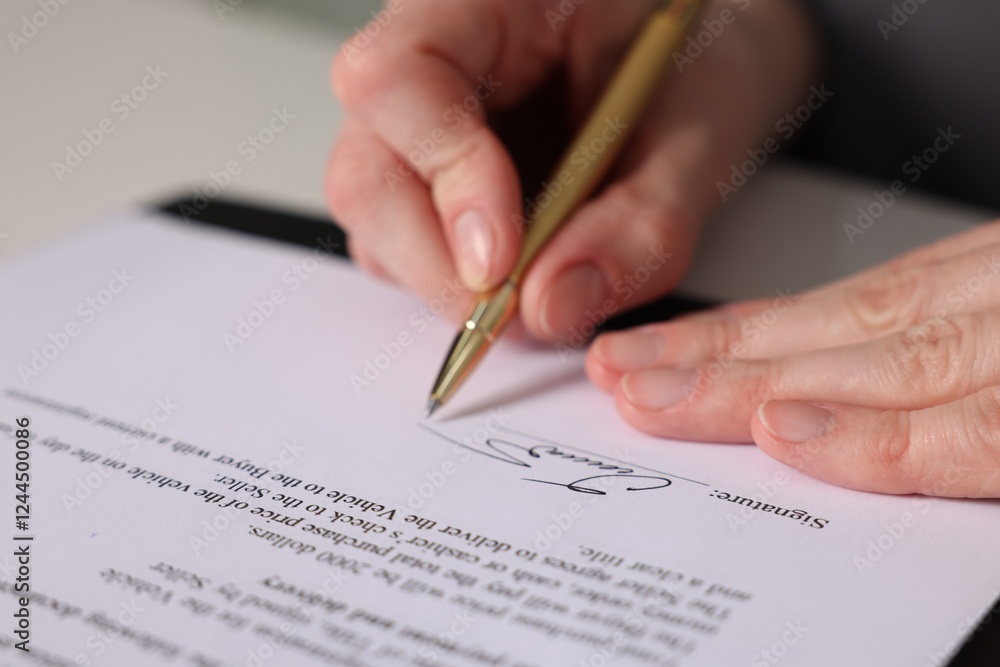 Woman putting signature on document at table, closeup Woman putting signature on document at table, closeup