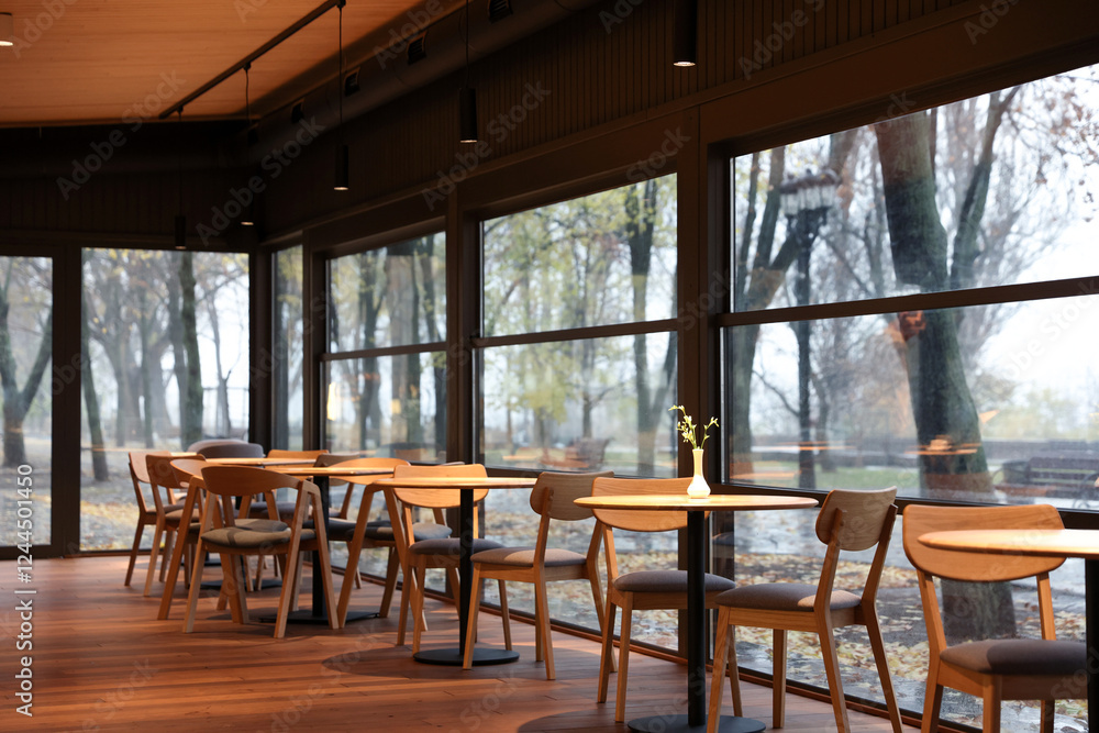 Stylish cafe with large windows and comfortable furniture. Interior design Stylish cafe with large windows and comfortable furniture. Interior design