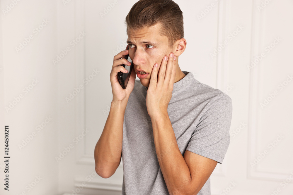 Stressed man calling hotline for mental health help indoors Stressed man calling hotline for mental health help indoors