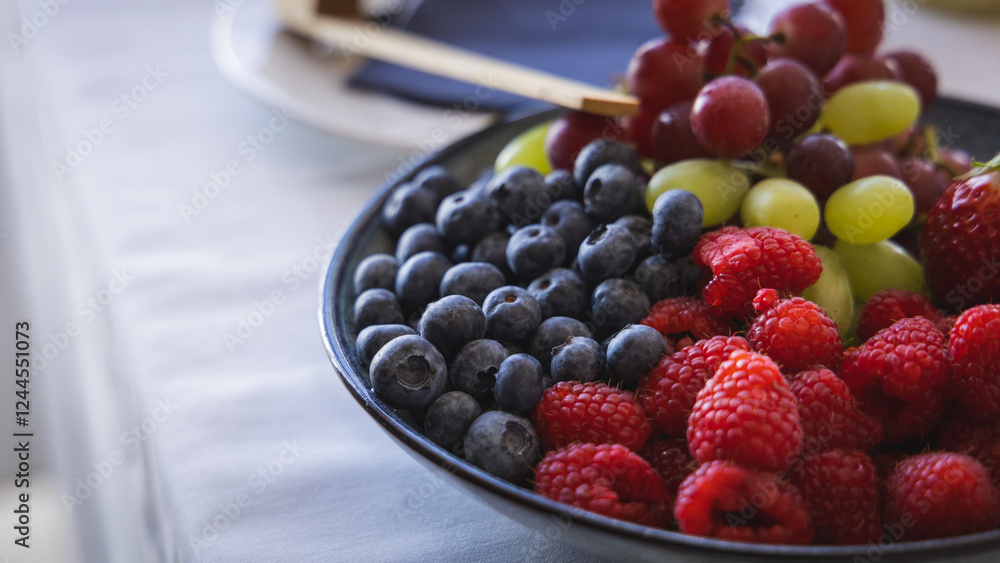 Different fruit such as blueberries, raspberries, grapes and strawberries on a display at a gala event or banquet. Self service food..