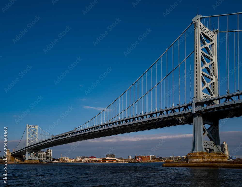 Fototapeta premium The architectural beauty that is the Ben Franklin Bridge spanning across the Delaware River between Camden NJ and Philadelphia Pennsylvania