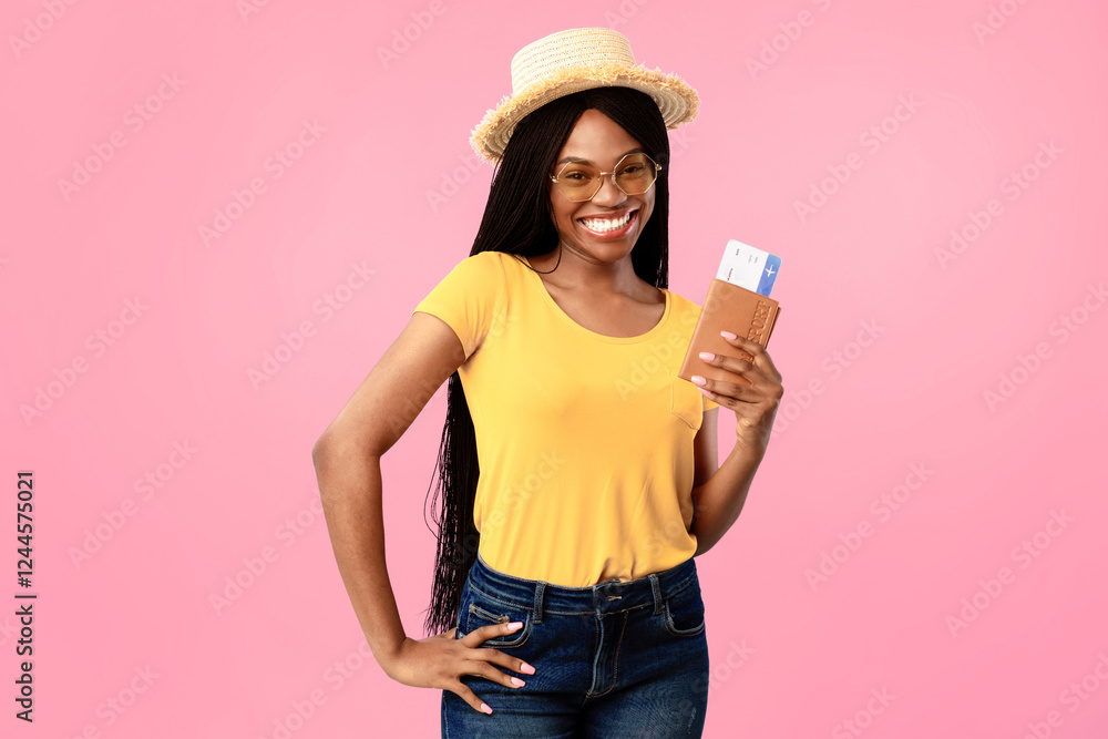 Cheap Flight Tickets. Cheerful Black Lady Tourist Holding Boarding Pass And Passport Posing Over Blue Studio Background, Wearing Hat And Sunglasses. Summer Vacation, Tourism And Traveling Cheap Flight Tickets. Cheerful Black Lady Tourist Holding Boarding Pass And Passport Posing Over Blue Studio Background, Wearing Hat And Sunglasses. Summer Vacation, Tourism And Traveling