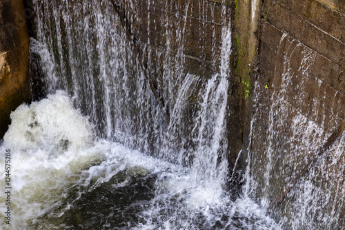 a leaking old wooden dam with a lot of holes