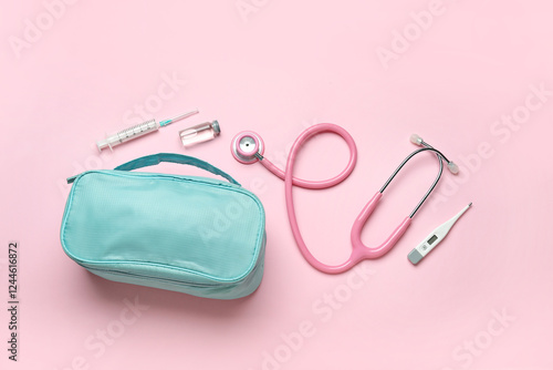 First aid kit on pink backg...
