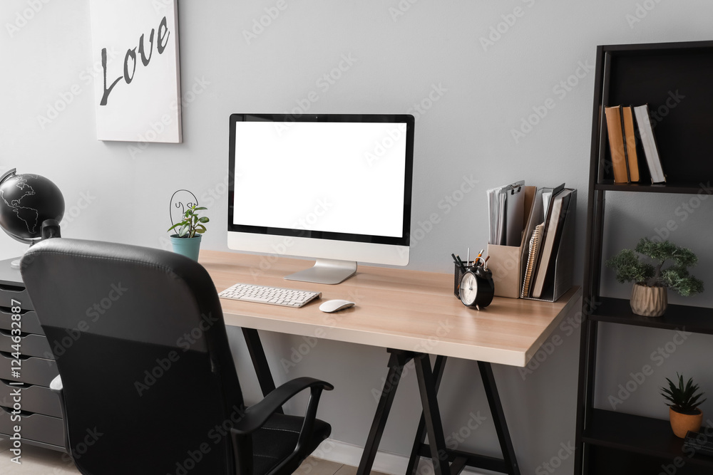 Blank computer monitor with alarm clock on table in office Blank computer monitor with alarm clock on table in office