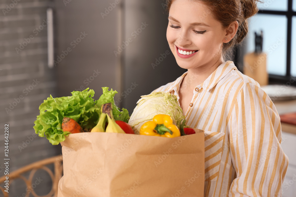 Young woman with paper bag of healthy food in kitchen, closeup Young woman with paper bag of healthy food in kitchen, closeup