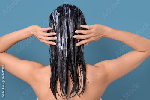 Asian woman applying hair m...