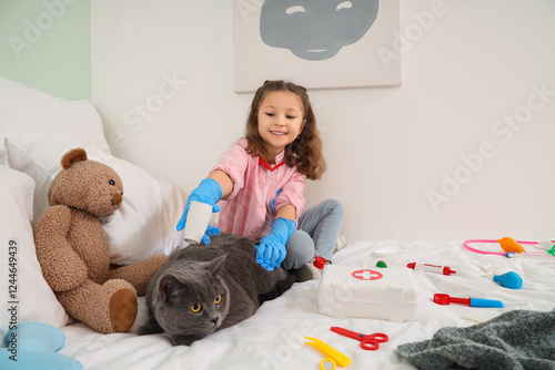 Little girl playing veterin...