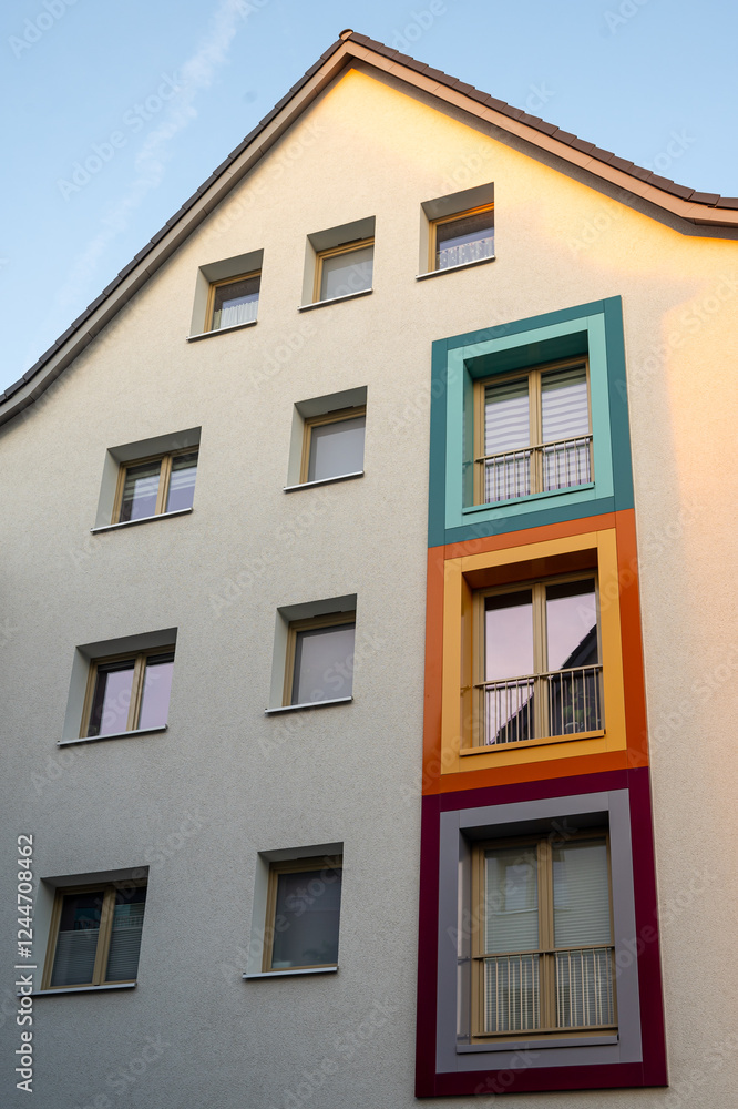 Facade of apartment buildings in Hannover, Germany. Exterior of residential building with colored window frames. Vertical orientation Facade of apartment buildings in Hannover, Germany. Exterior of residential building with colored window frames. Vertical orientation