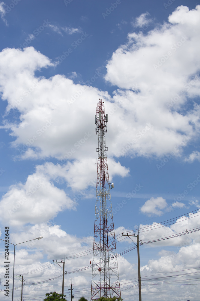 Red and white cell phone signal tower on bright sky background Red and white cell phone signal tower on bright sky background