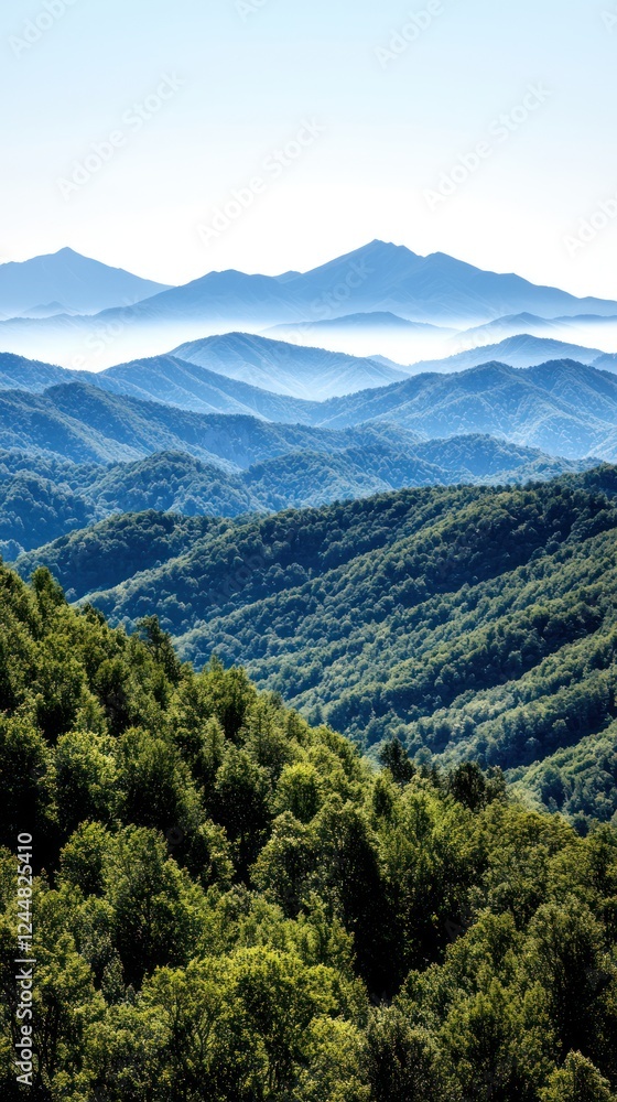A serene view of layered mountains and lush greenery under a clear blue sky.