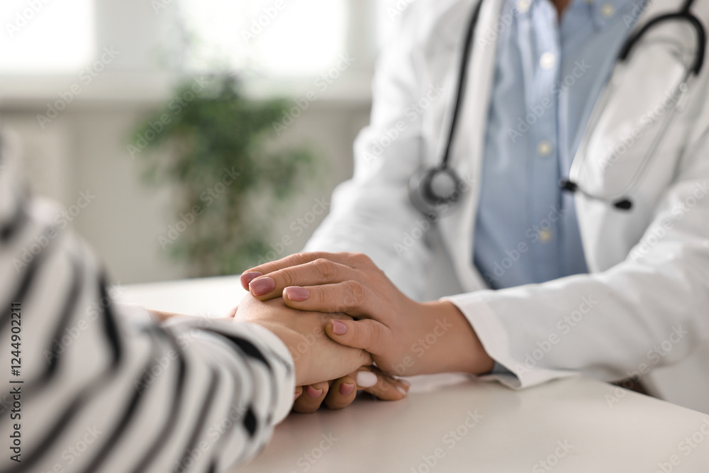 Fototapeta premium Doctor supporting patient during appointment in hospital, closeup of hands