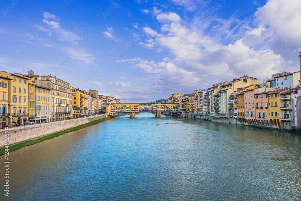 Fototapeta premium The Ponte Vecchio, Old Bridge, a Medieval stone closed-spandrel segmental arch bridge over the Arno River, with shops built along it; as jewelers, art dealers, souvenir sellers. Florence, Italy, 2019