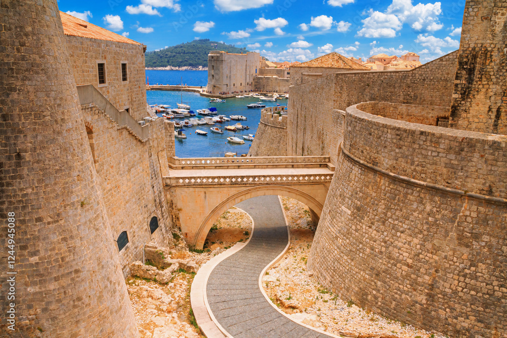 Summer cityscape - view of the bridge between the Revelin Fortress and the Ploce Gate in the Old Town of Dubrovnik on the Adriatic coast of Croatia
