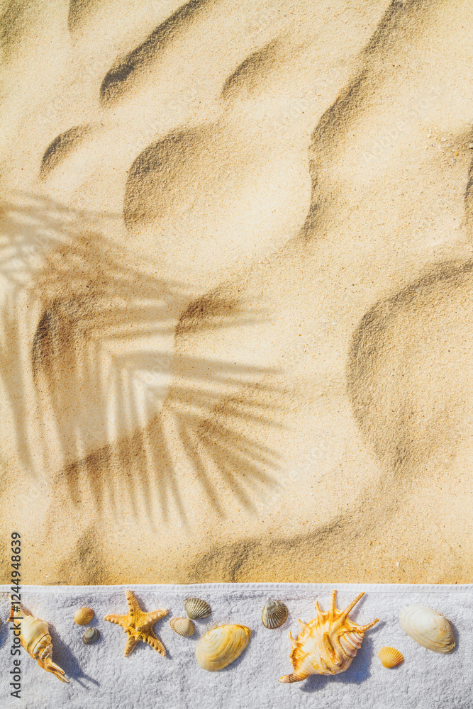 Top view of a beach with towel and seashells on the sand under the hot summer sun, vertical banner. Concept of sandy beach holiday, flat lay, background with copy space for text