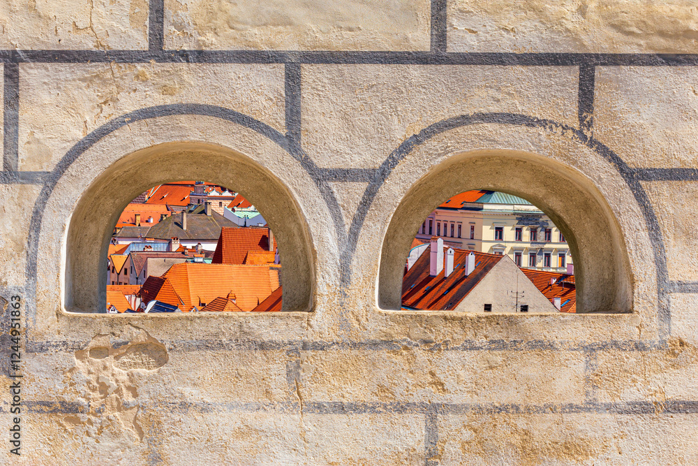 Summer cityscape - top view through the loopholes of the Cesky Krumlov Castle to the historical center of Cesky Krumlov, Czech Republic