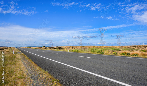 Desert Road in summer. Power pylons and power lines along the highway. North Island. New Zealand.