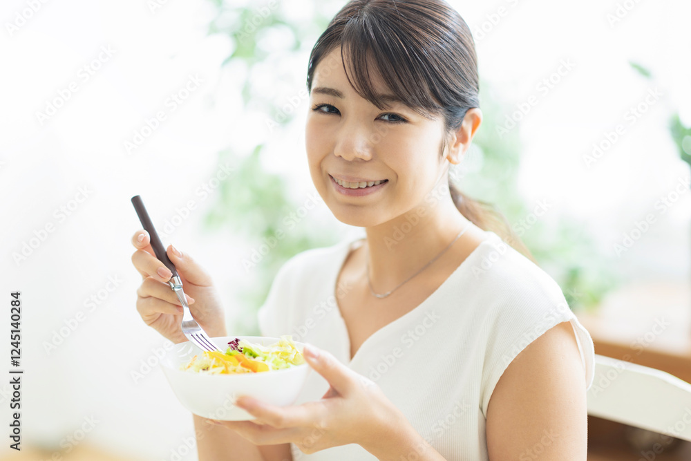 サラダを食べる若い女性