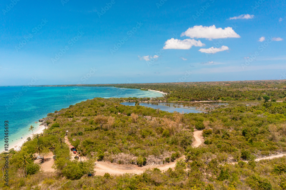 Tropical landscape with turquoise sea surface with coral reef. Bantayan Island under the clear blue sky and clouds. Cebu, Philippines. Tropical landscape with turquoise sea surface with coral reef. Bantayan Island under the clear blue sky and clouds. Cebu, Philippines.