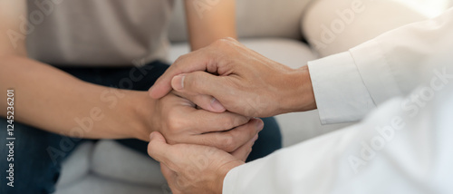Photos psychiatrist hold hand support each while discussing family issues