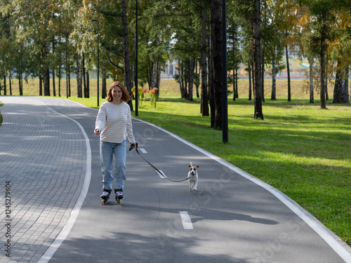 Wallpaper Mural Caucasian woman roller skating with her jack russell terrier dog in park.  Torontodigital.ca
