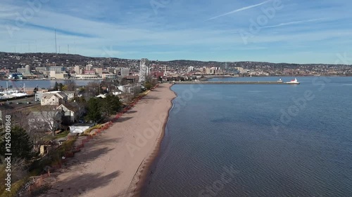 Wallpaper Mural Drone Flying over Beach next to houses and trees. Brown sand and blue water. Bridge and harbor in the back. Park Point in Duluth, Minnesota. Lake Superior Torontodigital.ca