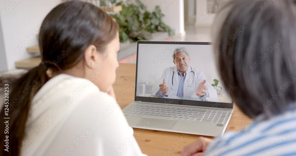 Having online consultation, biracial woman and elderly woman talking to doctor on laptop Having online consultation, biracial woman and elderly woman talking to doctor on laptop