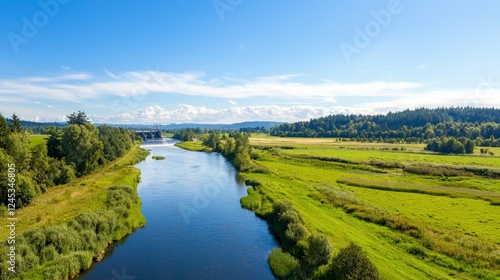 Wallpaper Mural Achieving Net Zero for a Sustainable Future with Lasting Impact, Lush river landscape under a clear blue sky, surrounded by green fields and distant mountains. Torontodigital.ca