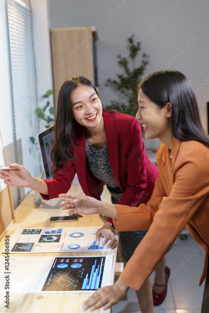 Fototapeta premium Businesswomen Collaborating on Digital Project in Office