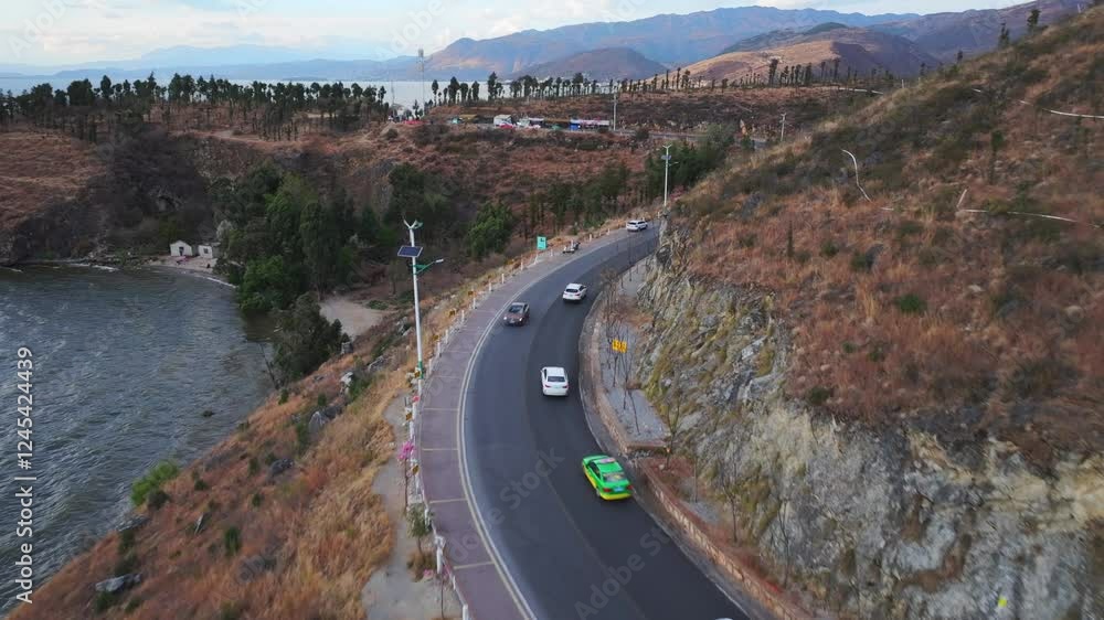 4k aerial video capturing traffic along Erhai Lake Ring Road in Dali, Yunnan under clear skies and scenic mountains 4k aerial video capturing traffic along Erhai Lake Ring Road in Dali, Yunnan under clear skies and scenic mountains