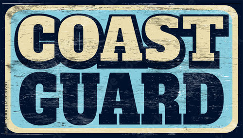 Aged and worn coast guard sign on wood